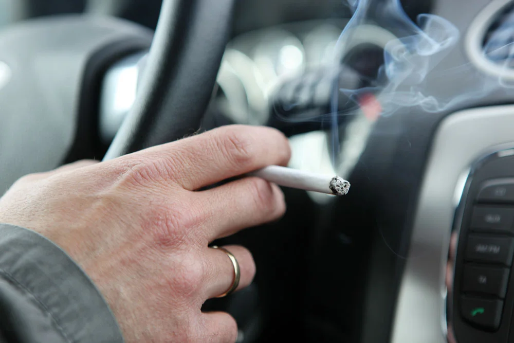 Man smoking inside the car
